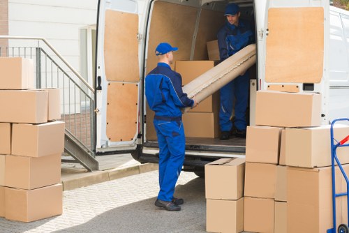Man and van moving boxes in a Hackney residential street