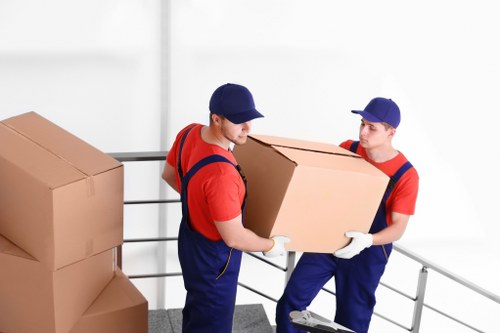 Moving team handling boxes in a Hackney residential street
