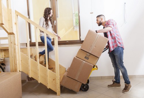 Packed moving boxes and furniture ready for transport in Hackney
