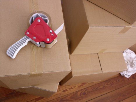 Professional movers handling boxes in a Hackney flat move