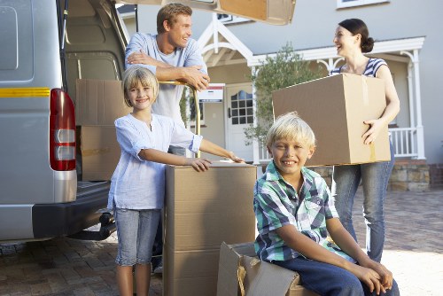Movers handling house contents in a Hackney flat with stairs